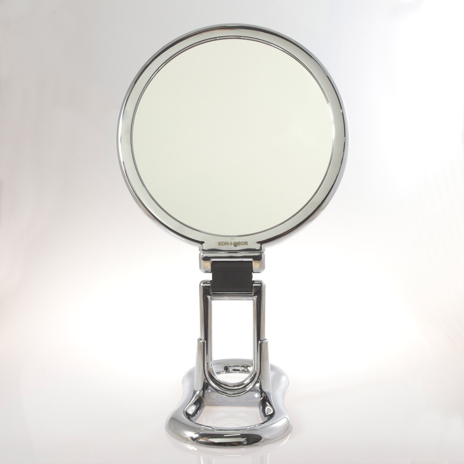 Specchio cromato bifacciale con ingrandimento x 6, manico pieghevole e  supporto da tavolo. Ø18cm.Cromo